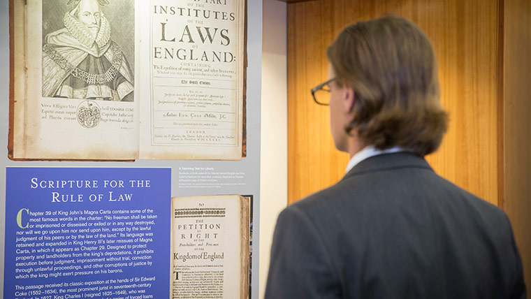 A student views an exhibit of the Magna Carta at a display on campus.