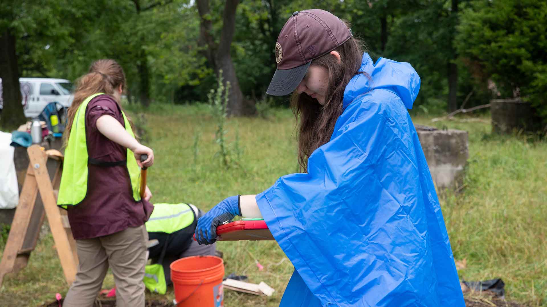 Two students working at a historical site during an archaeological dig.