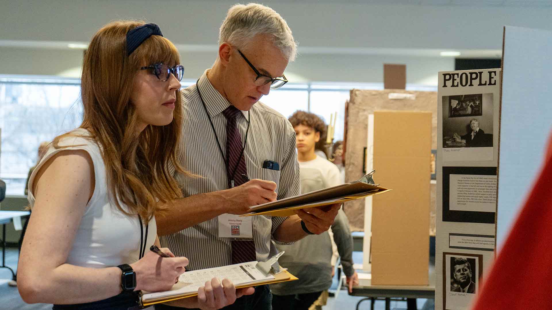 Two judges reviewing submissions during National History Day.