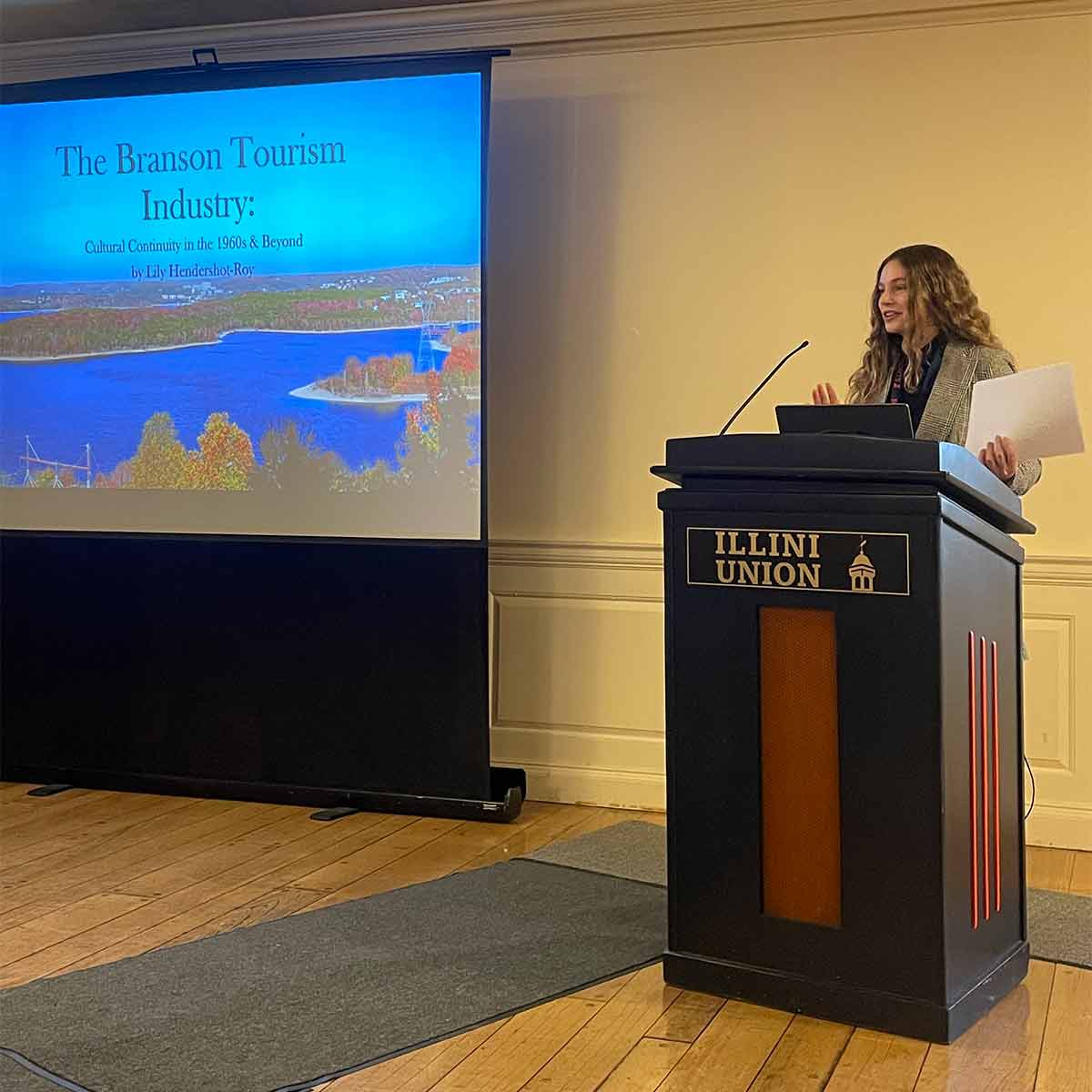 A Phi Alpha Theta members gives a presentation on the Branson Tourism Industry at a conference.